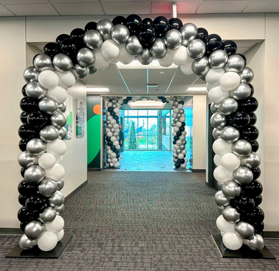 Organic balloon arch in black silver and white for event entrance and venue decor in Fort Worth DFW