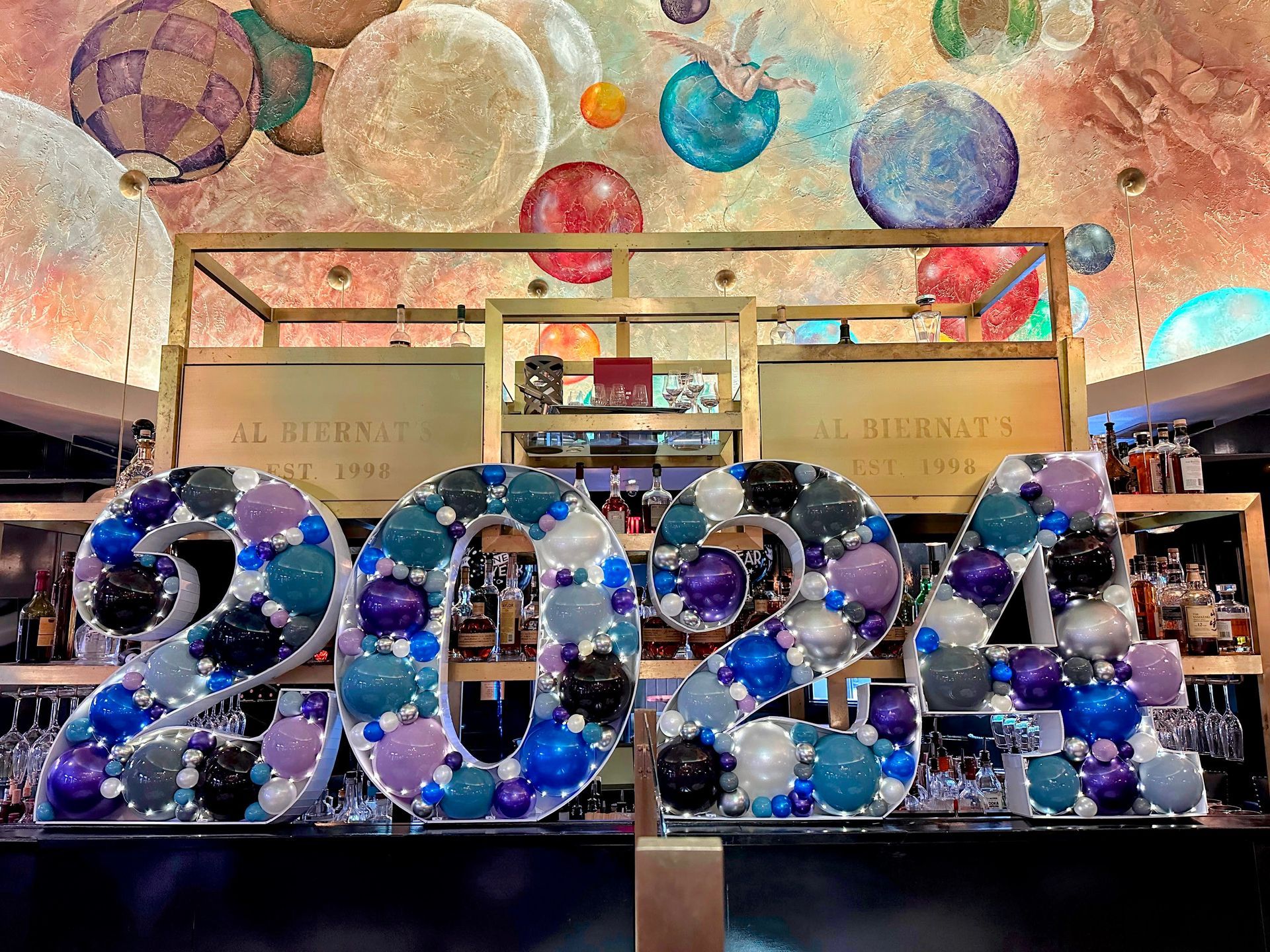 The numbers 2022 are made of balloons and are displayed in a store.