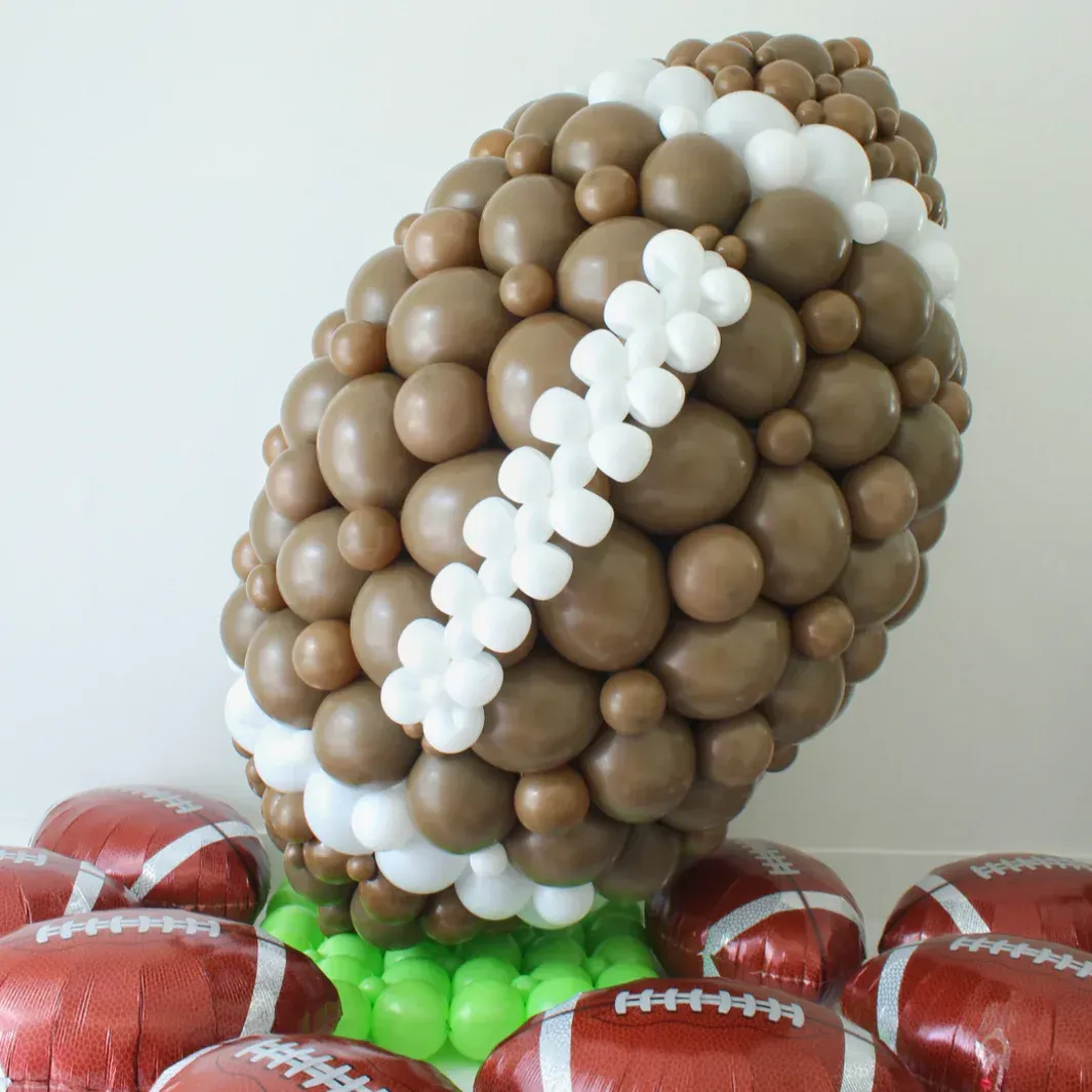 Football-themed balloon sculpture ideal for sports parties, school events, and game day celebrations