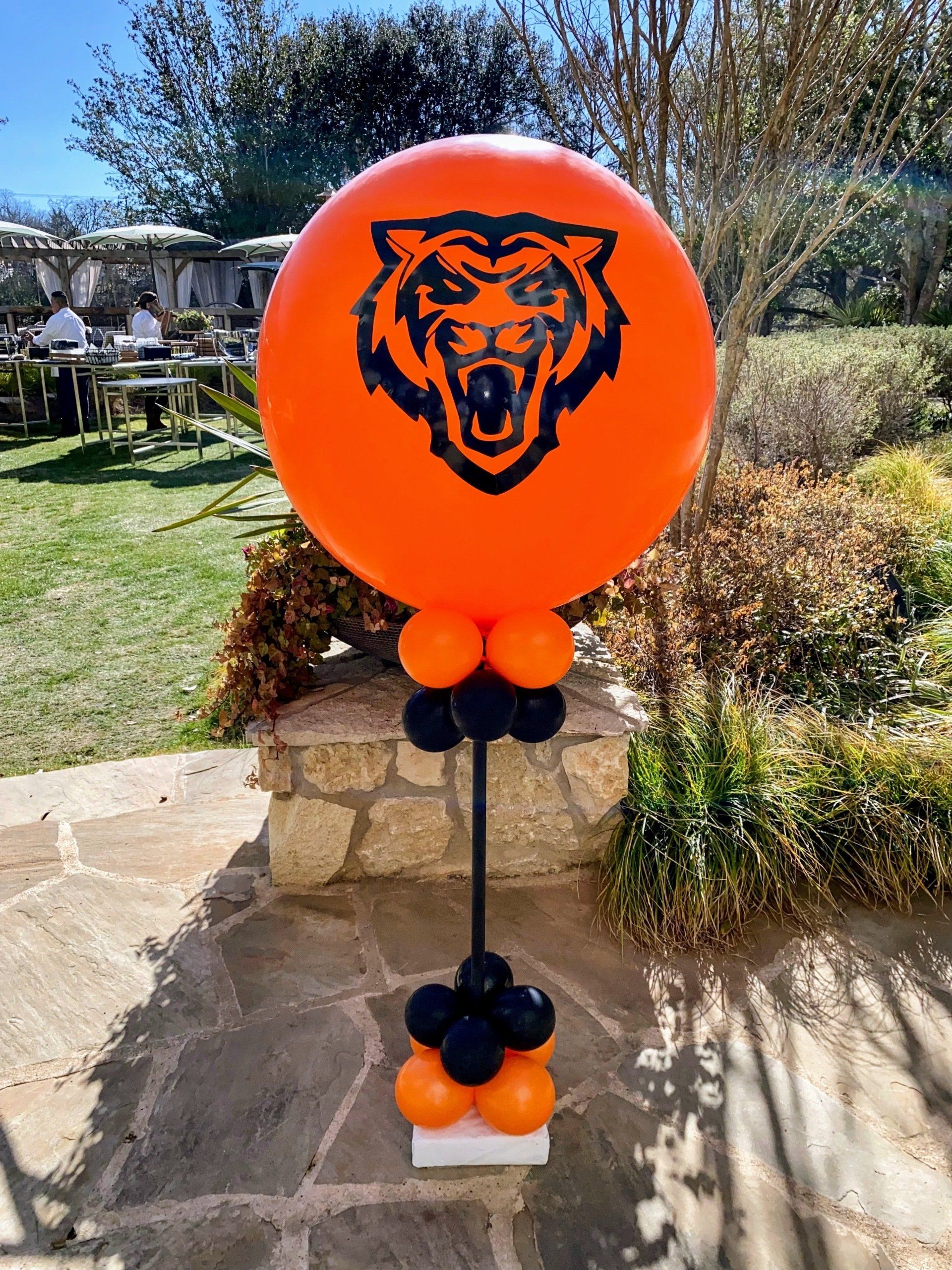A large orange balloon with a bear head on it