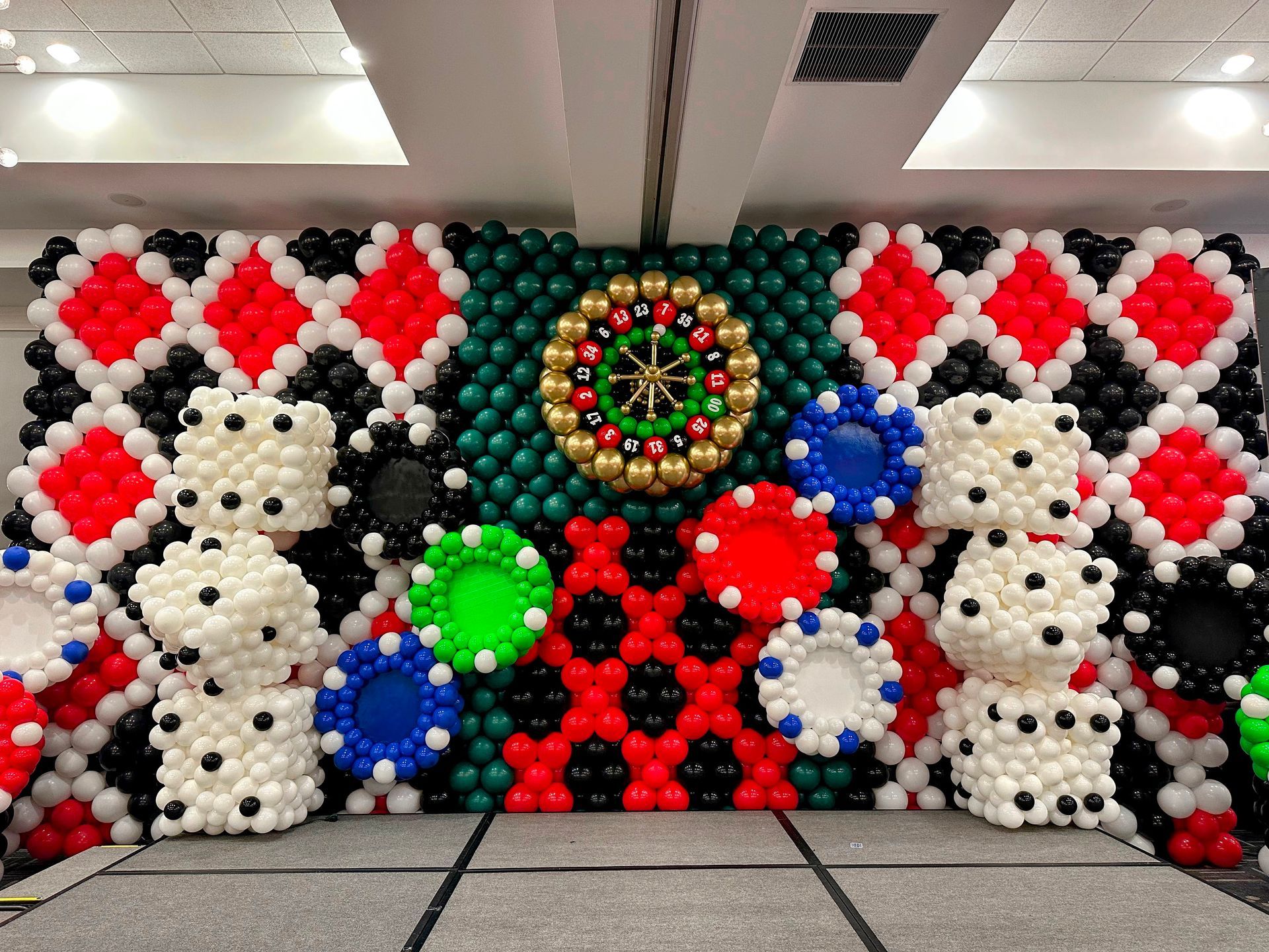 Custom balloon wall installation with themed balloon designs for corporate or promotional event