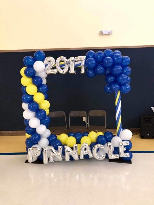 A picture frame made of balloons with the name pinnacle on it