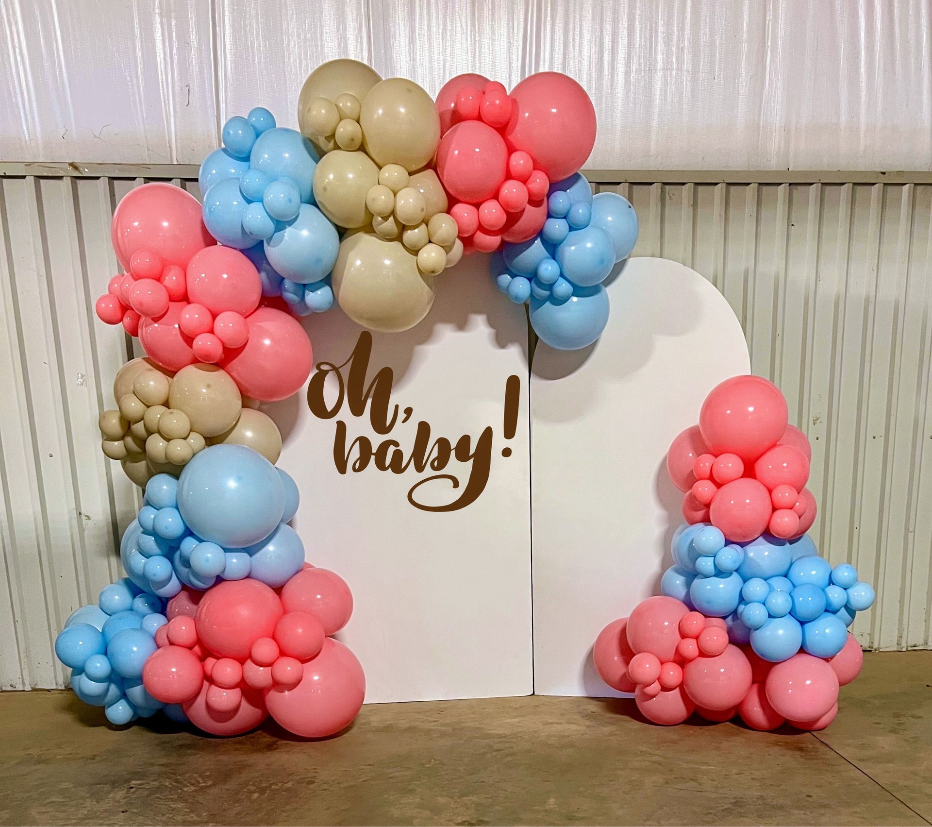 Colorful gender reveal balloon garland backdrop for baby shower setup in Fort Worth Texas