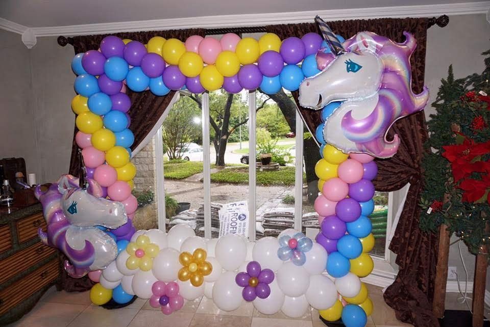 A room decorated with balloons and a unicorn balloon.