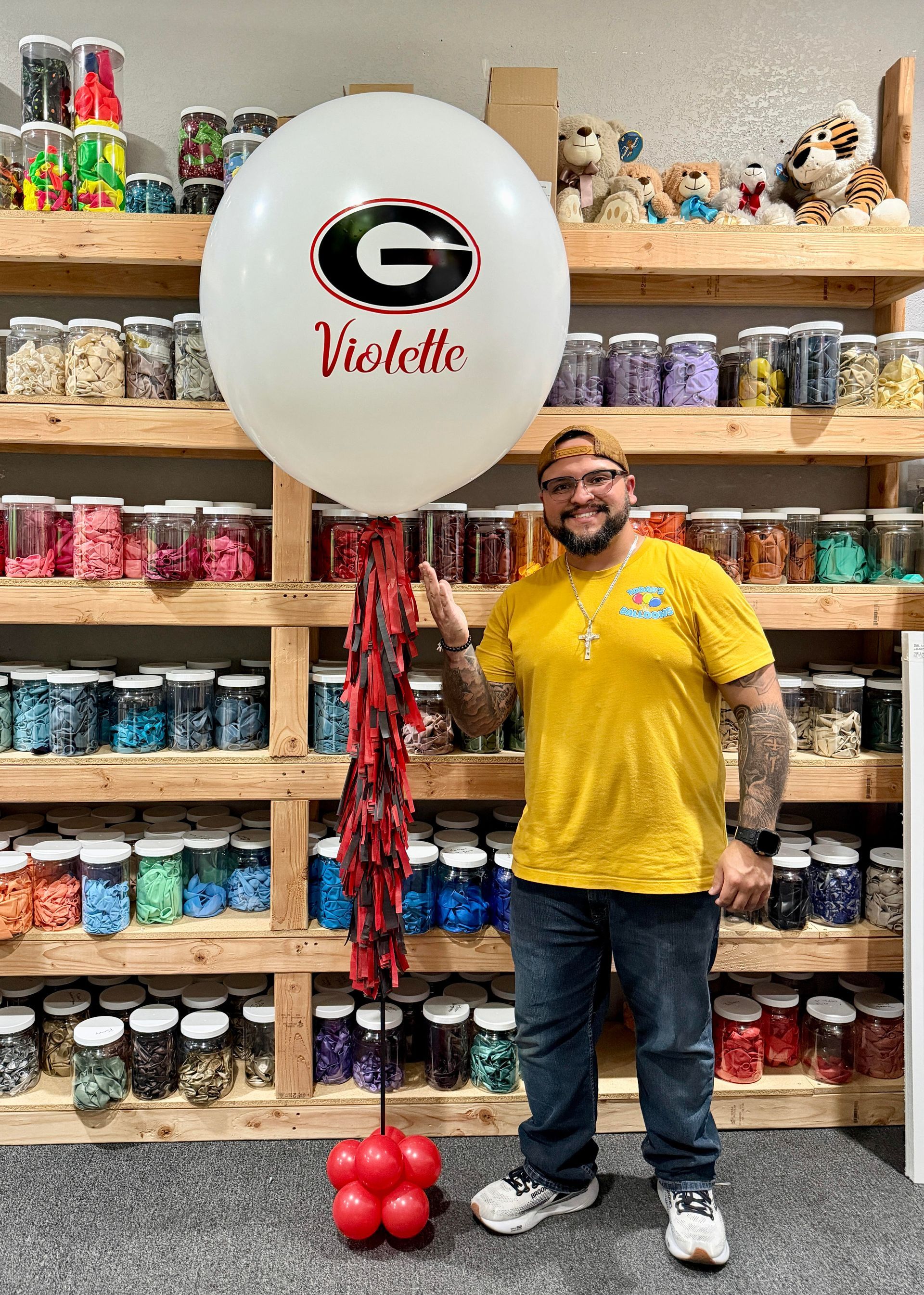 Personalized jumbo helium balloon display with custom name design, school-themed colors, and oversized balloon decor for celebrations and events.