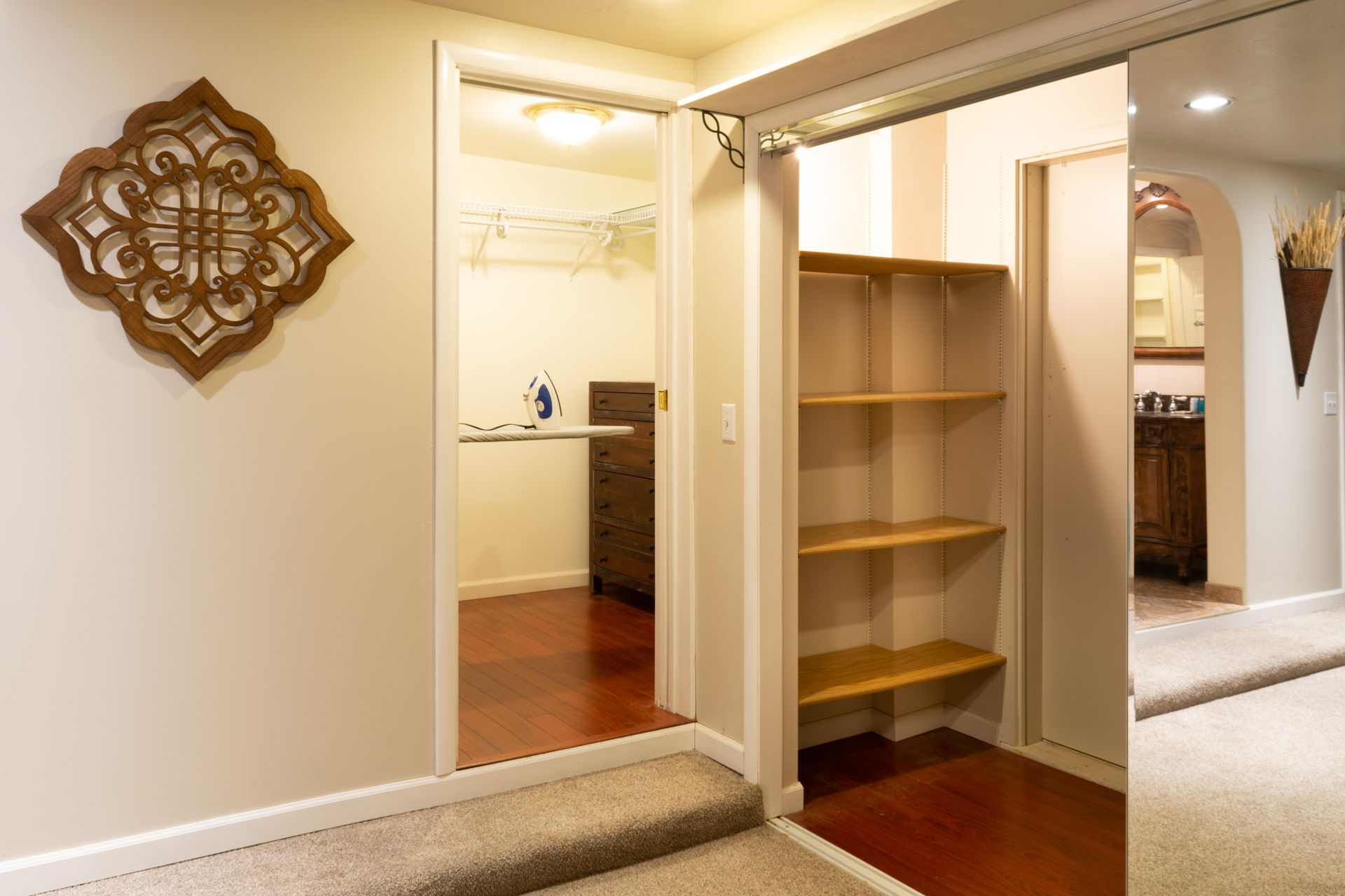 Interior view with doorway, shelving, and mirror.
