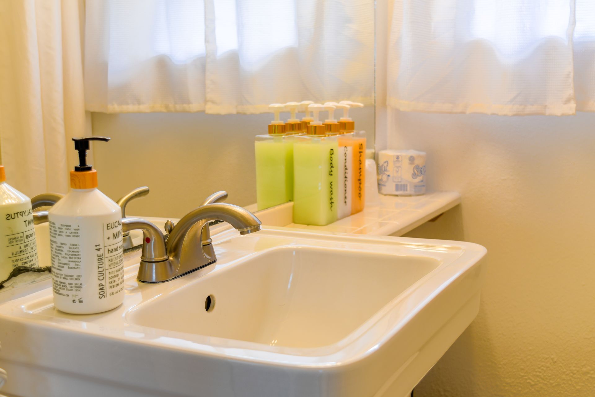 A white porcelain sink with a chrome faucet.