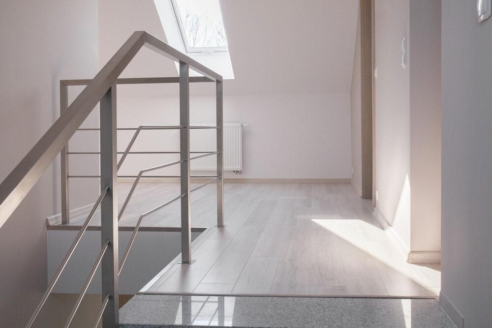 A Staircase With a Stainless Steel Railing in a Hallway — Kymar Steel Fabrications in Teralba, NSW