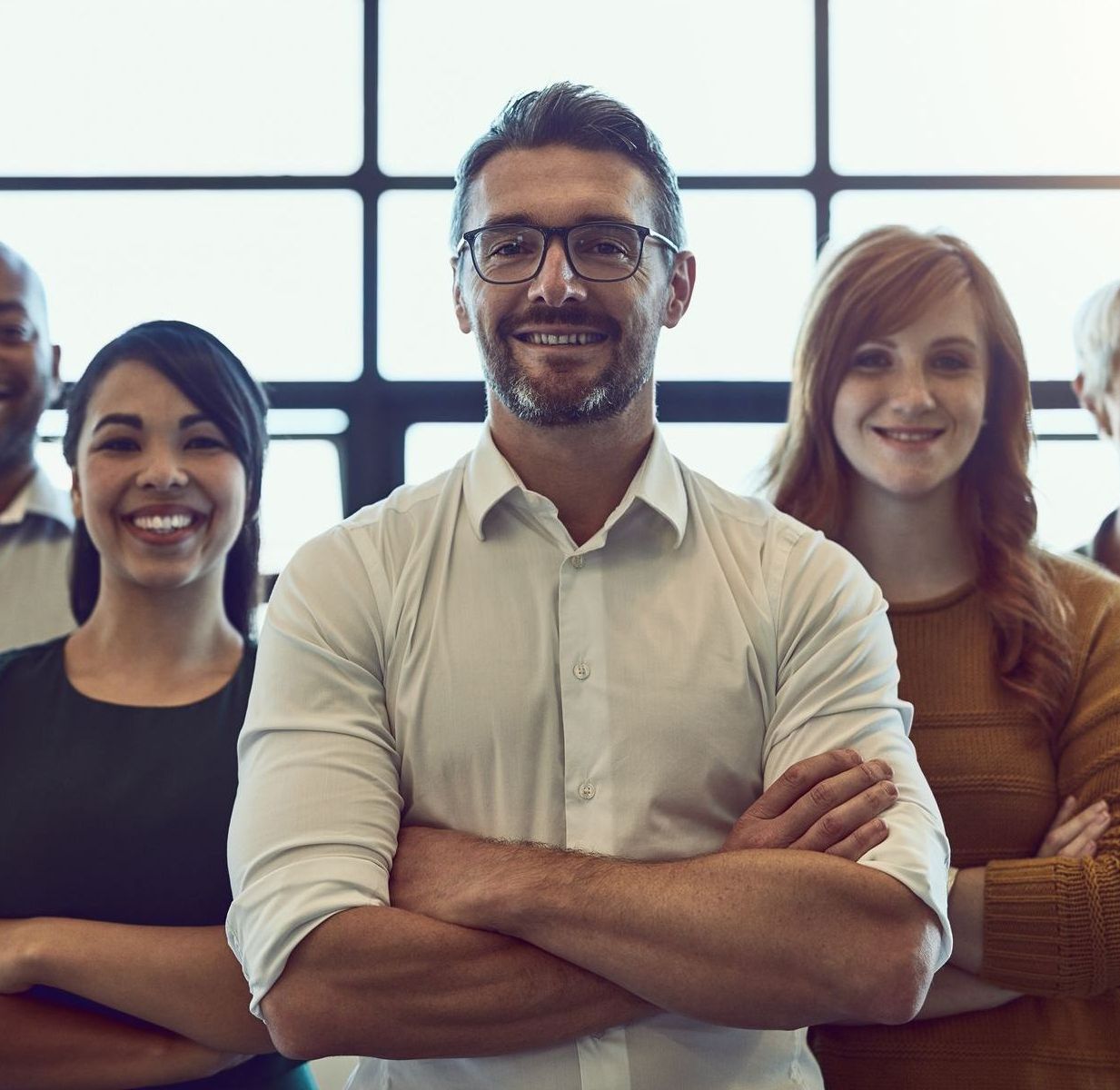 A group of people are sitting around a conference table having a meeting.