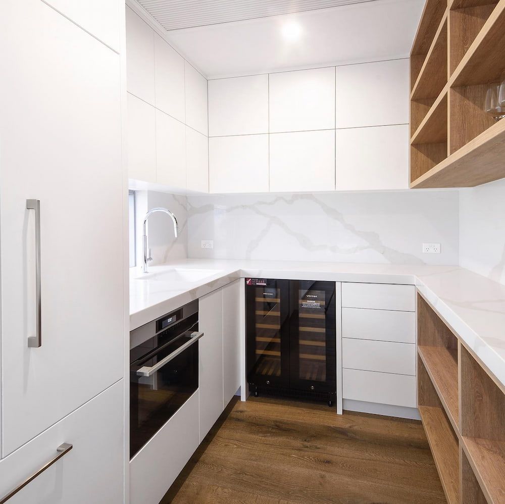 A Kitchen With White Cabinets And A Wine Cooler — Cross Cabinets In Sunshine Coast Hinterland, QLD