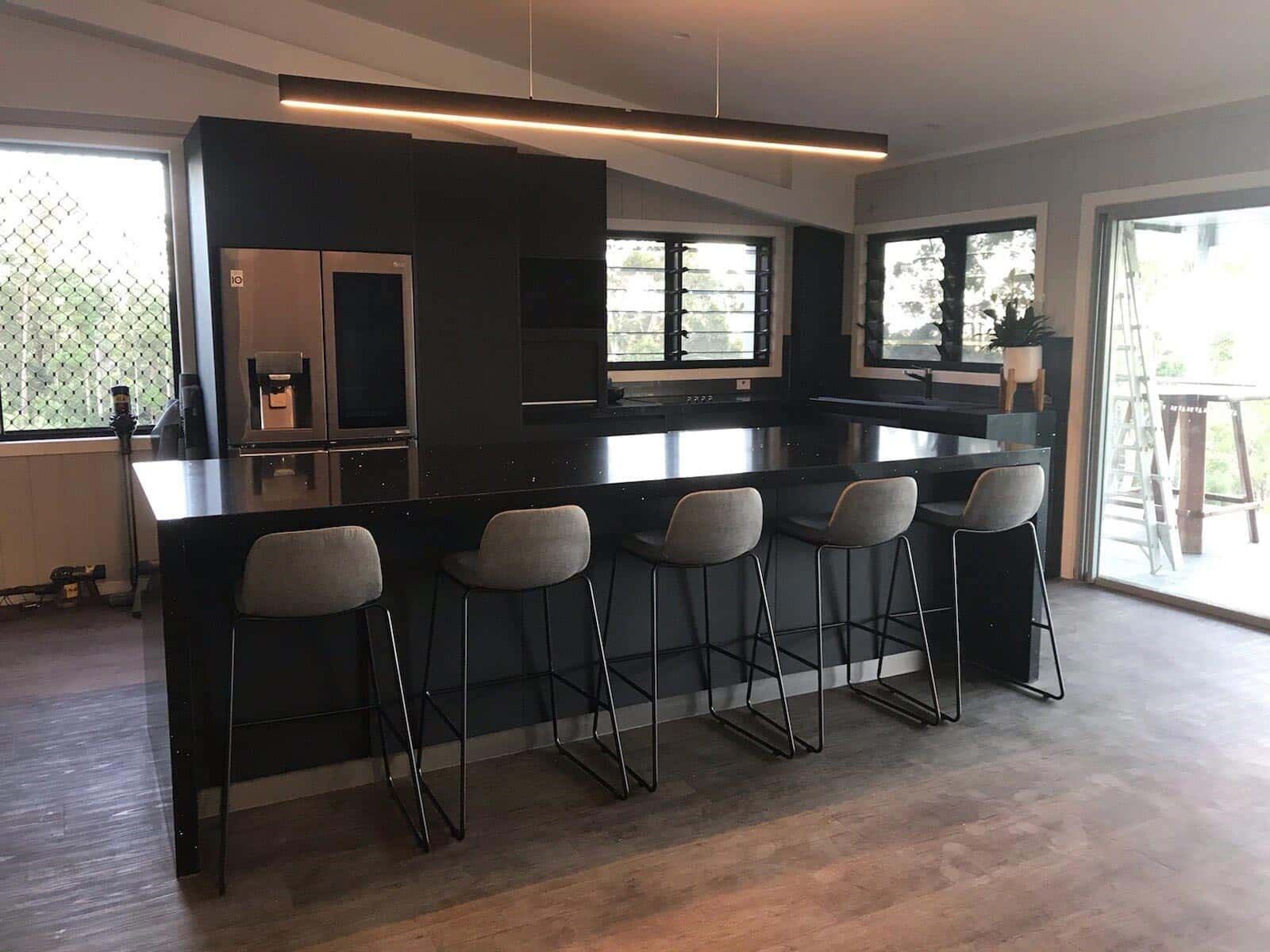 A Kitchen With A Large Island, Stools And A Refrigerator — Cross Cabinets In Chevallum, QLD