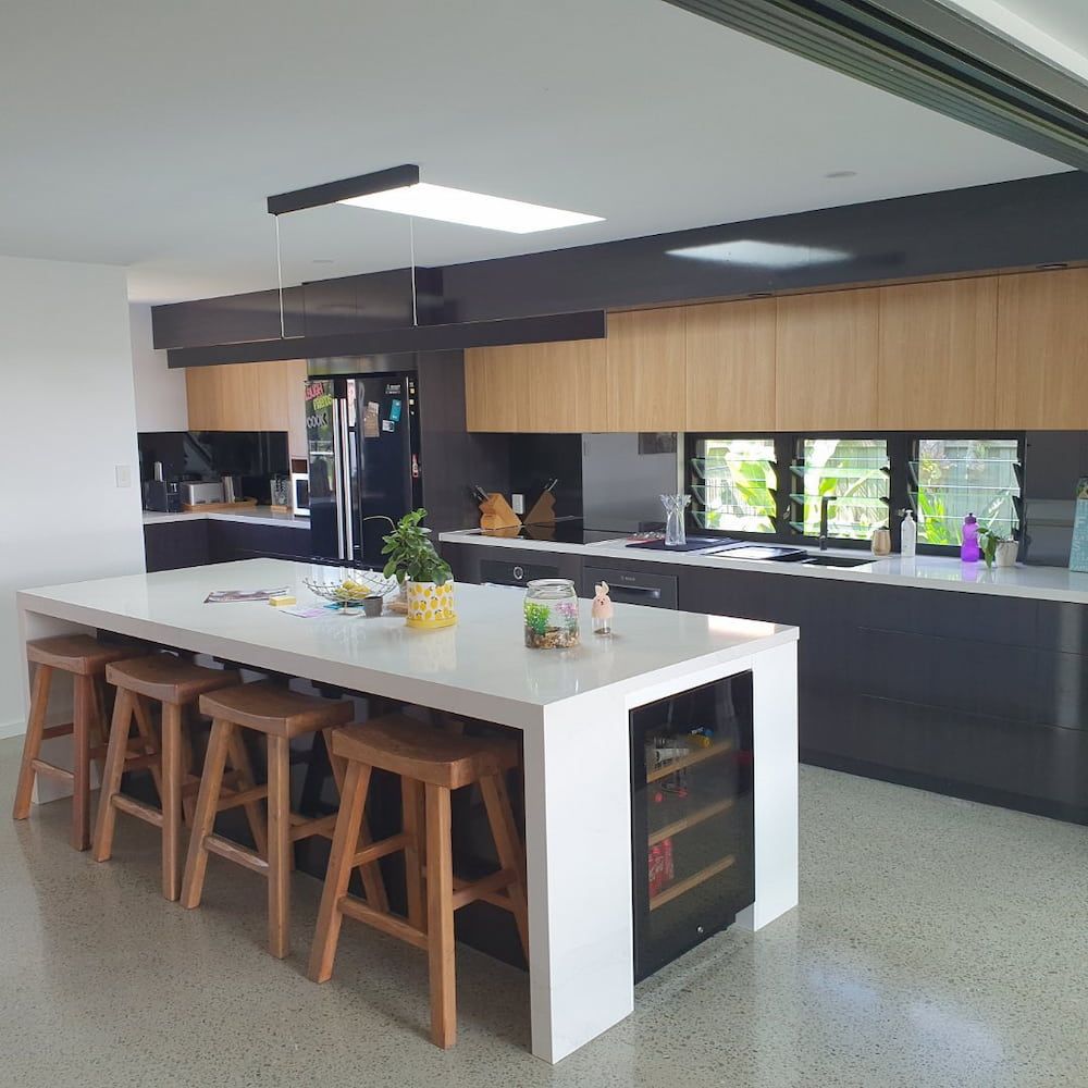 A Kitchen With A Large Island And Stools — Cross Cabinets In Caboolture, QLD