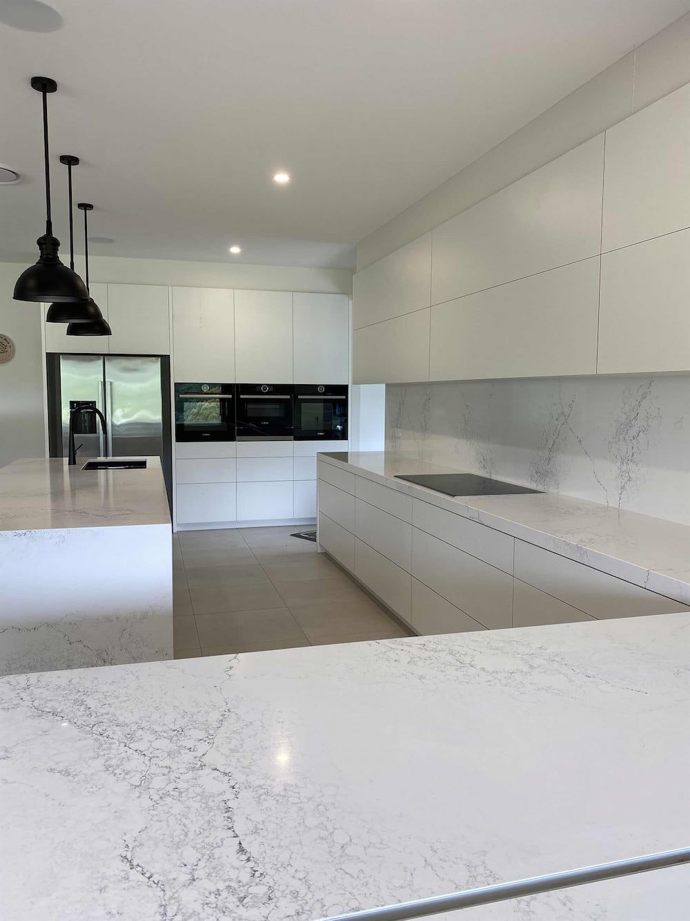 A Kitchen With White Cabinets And White Counter Tops — Cross Cabinets In Chevallum, QLD
