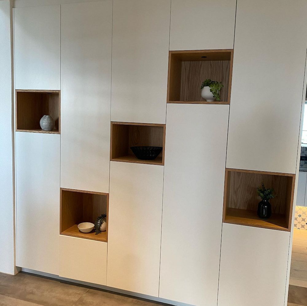 A White Cabinet With Wooden Shelves In A Room — Cross Cabinets In Chevallum, QLD