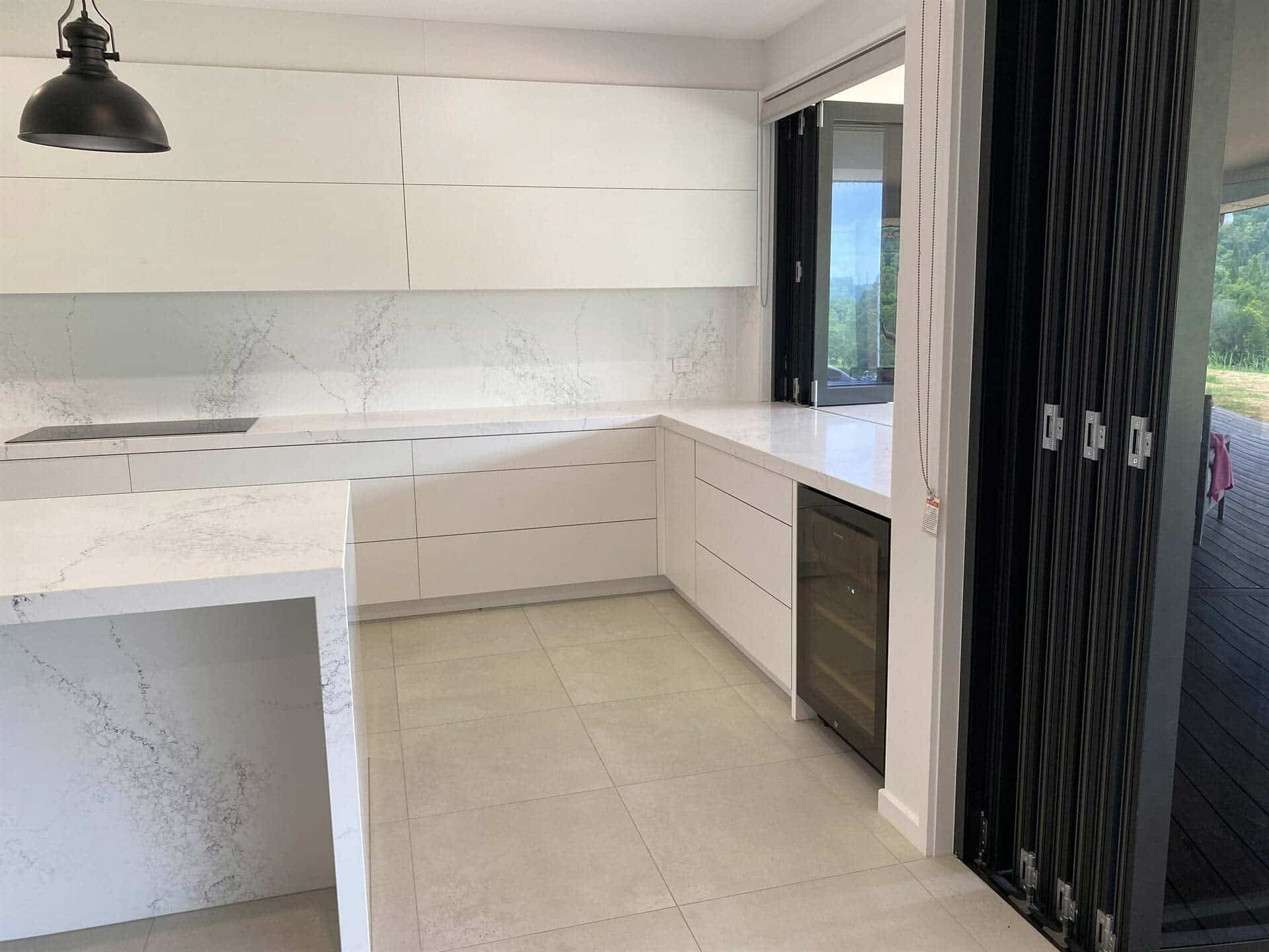 A Kitchen With White Cabinets And A Black Door — Cross Cabinets In Chevallum, QLD