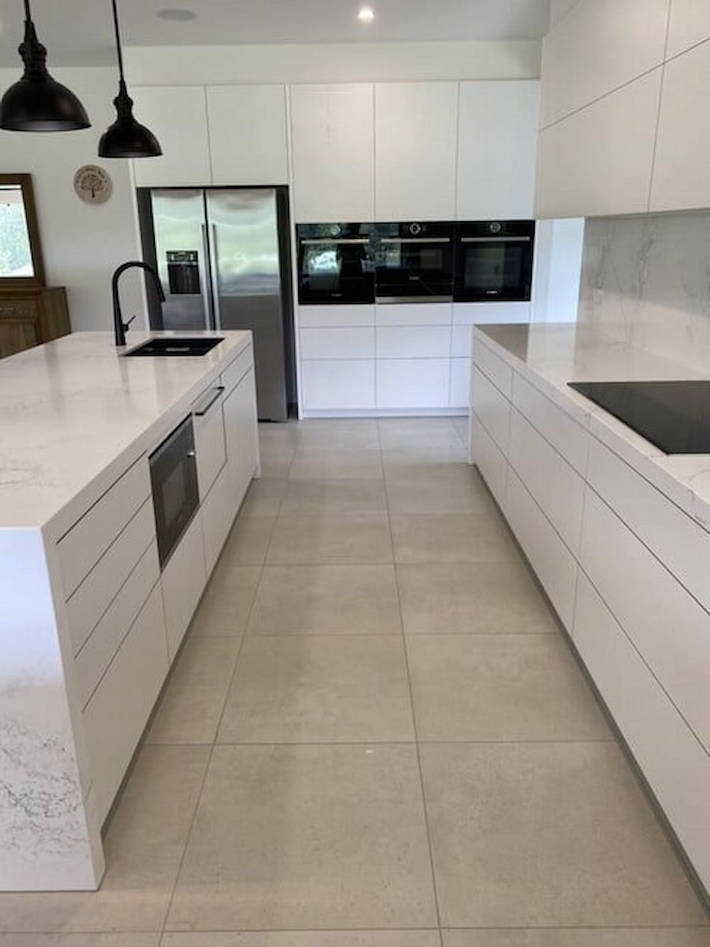 A Kitchen With White Cabinets And Stainless Steel Appliances — Cross Cabinets In Chevallum, QLD