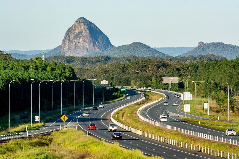 A Highway With A Mountain In The Background And Cars Driving Down It — Cross Cabinets In Sunshine Coast Hinterland, QLD