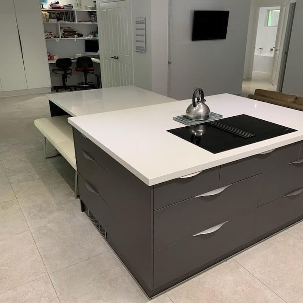 A Kitchen With A Large Island And A Stove Top Oven — Cross Cabinets In Chevallum, QLD