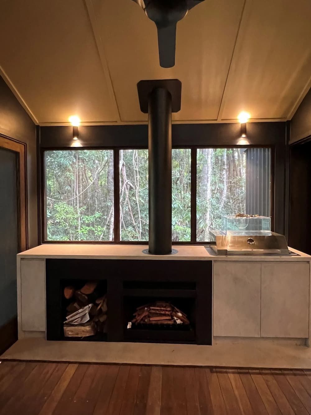 A Room With A Fireplace And A Ceiling Fan — Cross Cabinets In Chevallum, QLD