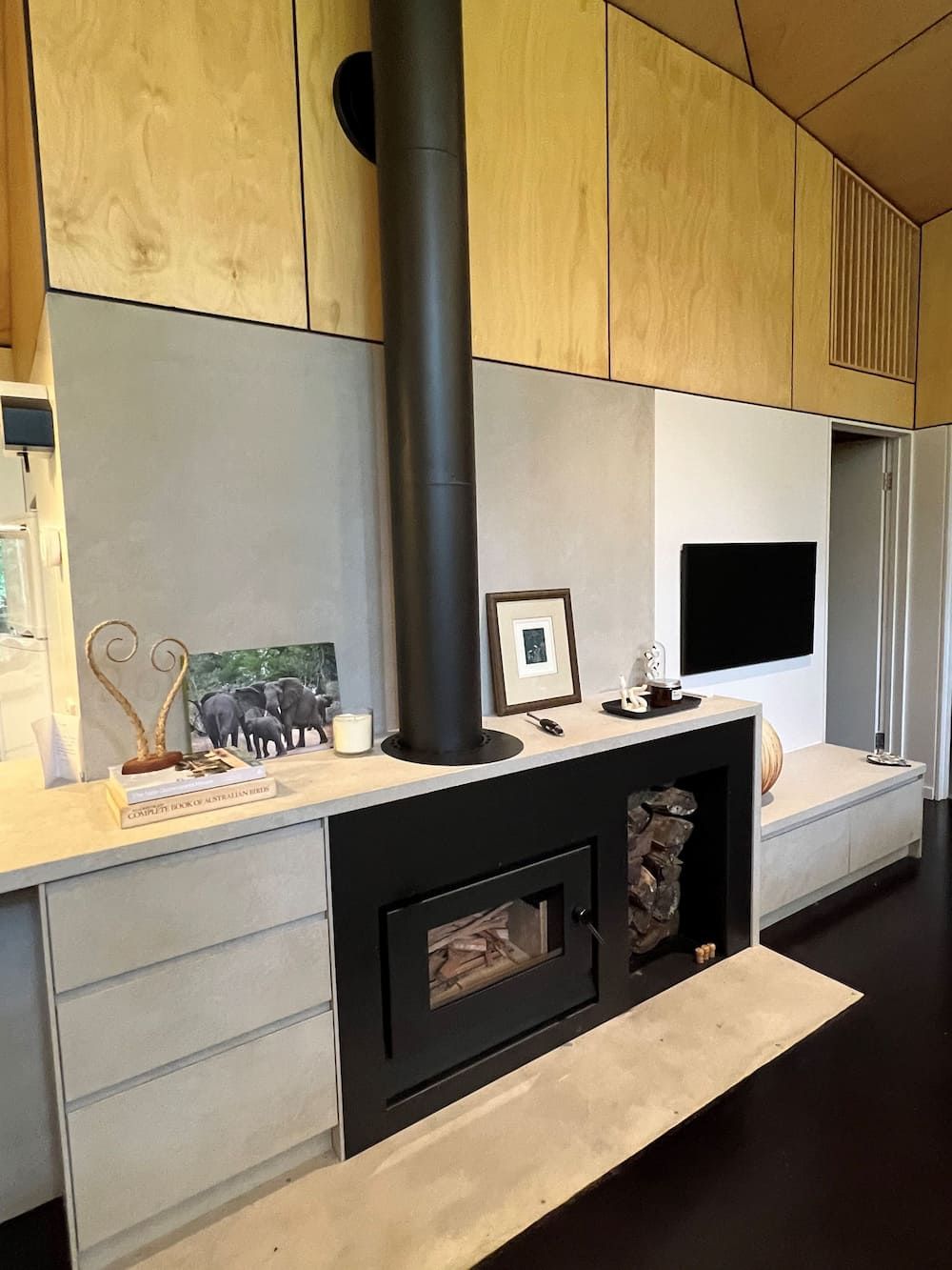 A Living Room With A Fireplace And A Television — Cross Cabinets In Caloundra, QLD