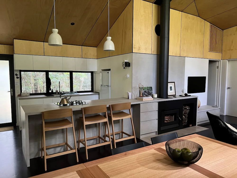 A Kitchen With A Table And Chairs In It — Cross Cabinets In Chevallum, QLD