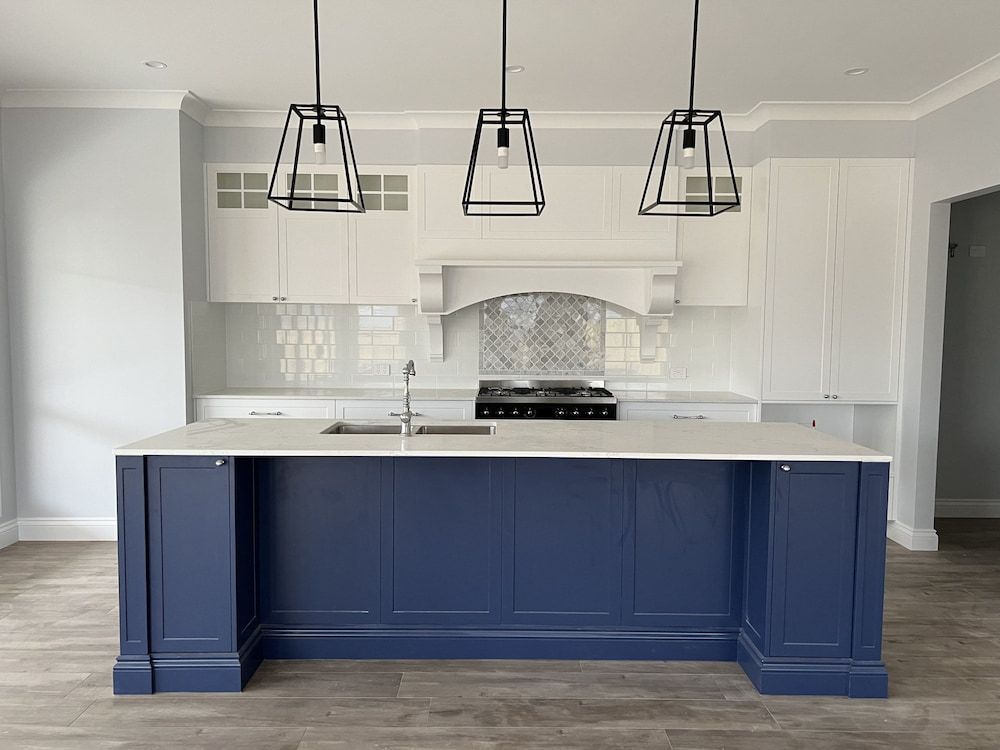 A Kitchen With Blue Cabinets And White Counter Tops — Cross Cabinets In Brisbane, QLD