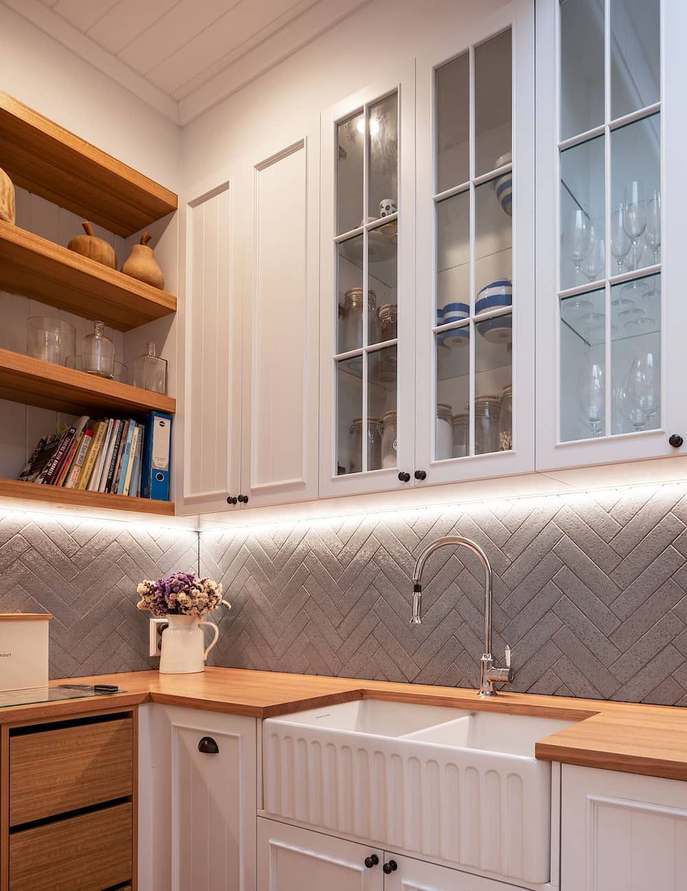 A Kitchen With White Cabinets, Wooden Counter Tops, A Sink, And Glass Doors — Cross Cabinets In Chevallum, QLD