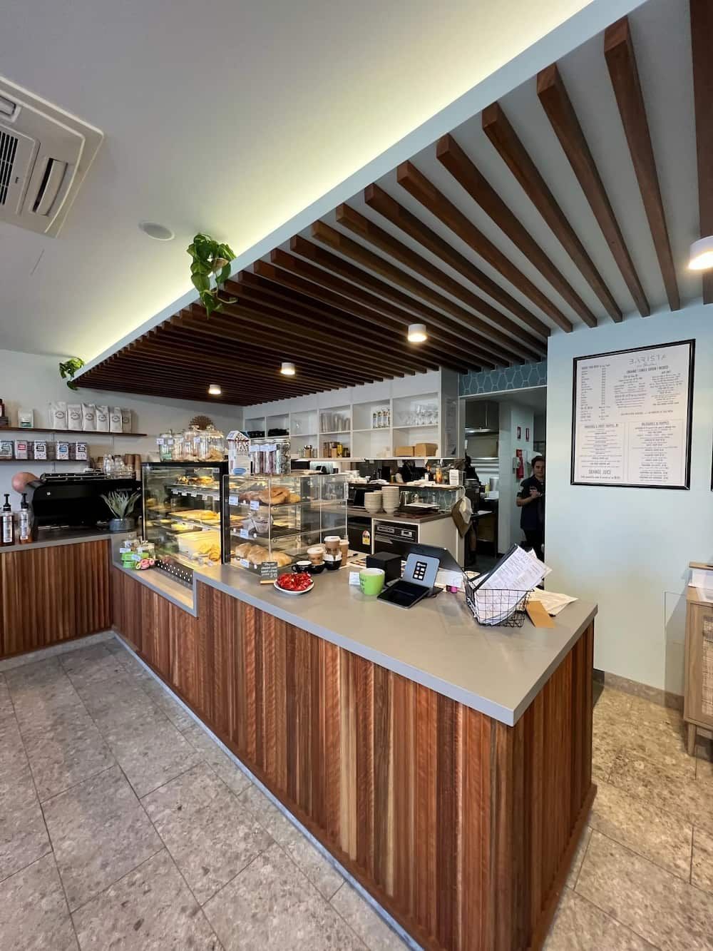 A Large Wooden Counter In A Restaurant With A Ceiling Made Of Wooden Beams — Cross Cabinets In Chevallum, QLD