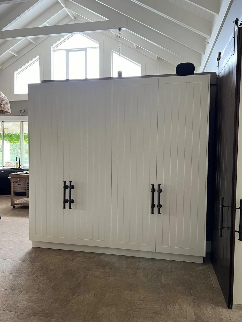A Large White Cabinet With Black Handles In A Living Room — Cross Cabinets In Chevallum, QLD