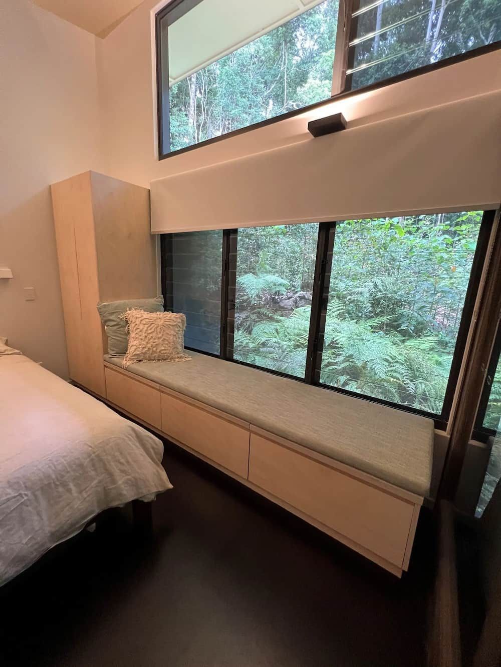 A Bedroom With A Bed And A Window Seat — Cross Cabinets In Chevallum, QLD