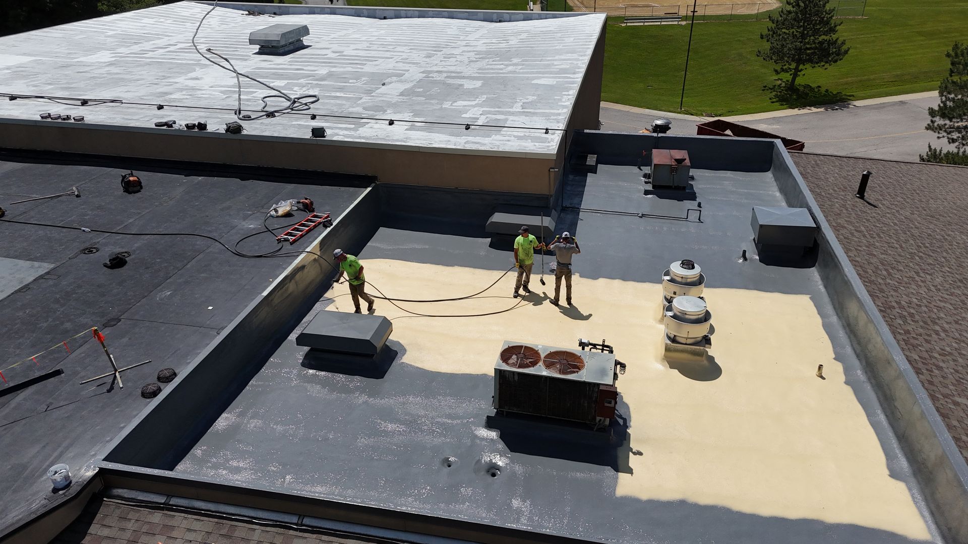 silicone coating being installed over spray polyurethane foam
