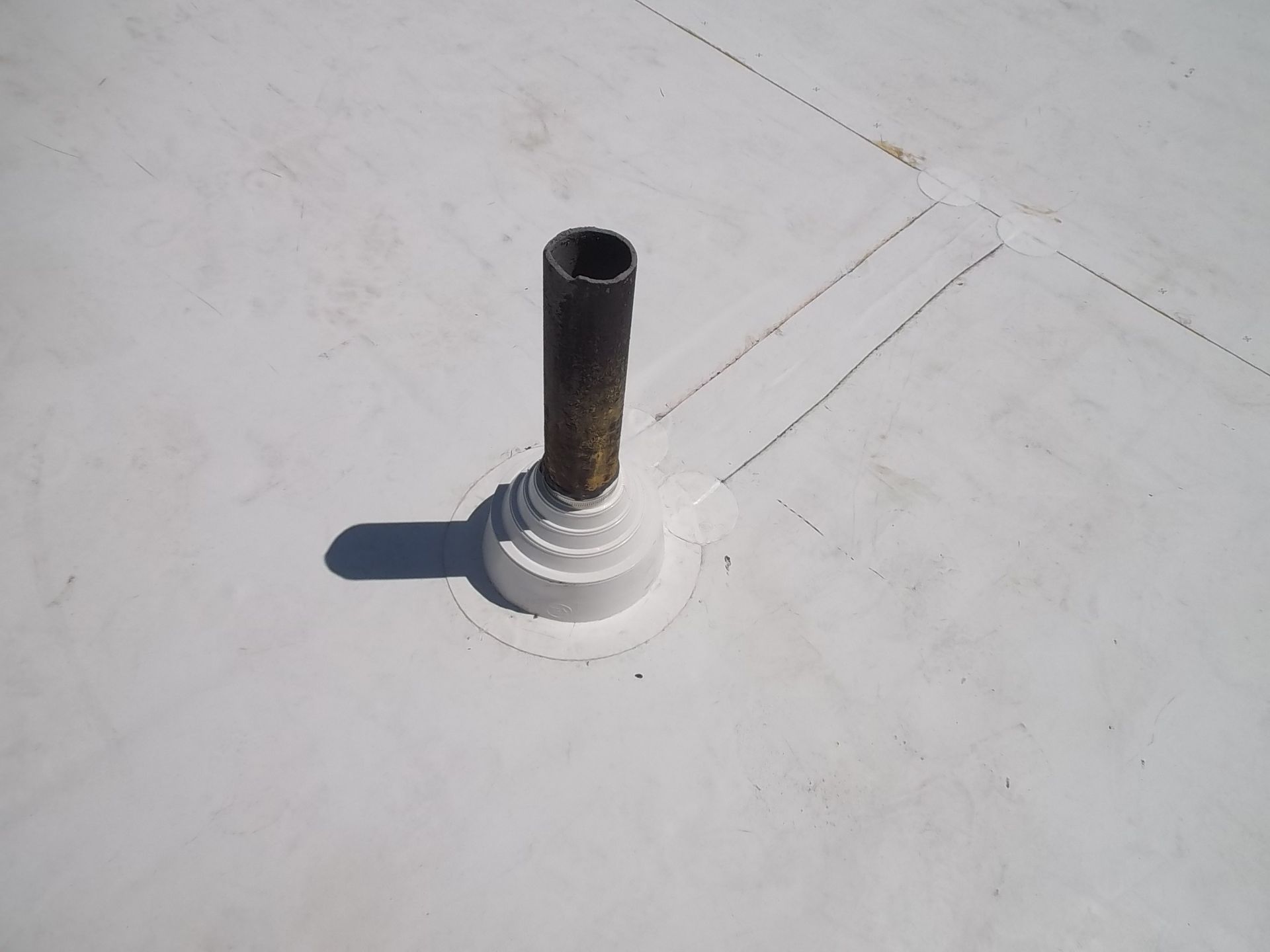 TPO installed around a pipe on a commercial roof