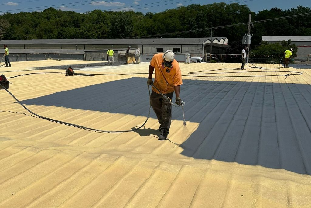Coating being installed over a spray foam roof in Akron, Ohio