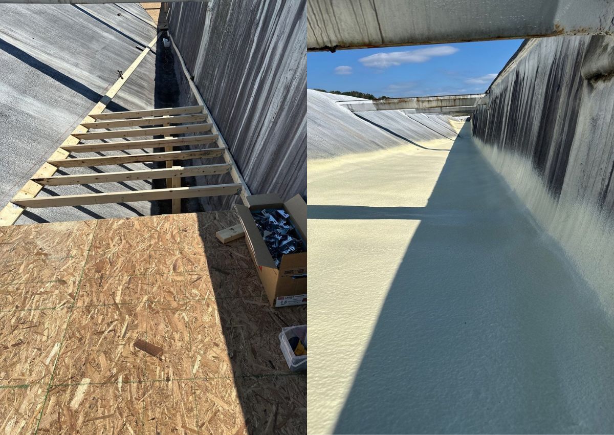 Construction site with plywood walkway beside a large metal-lined channel or tank, under an open sky