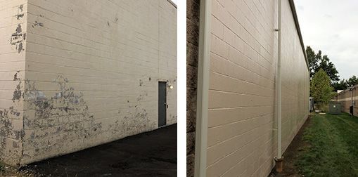 Exterior of a beige building with peeling paint and a long side wall beside a grassy path