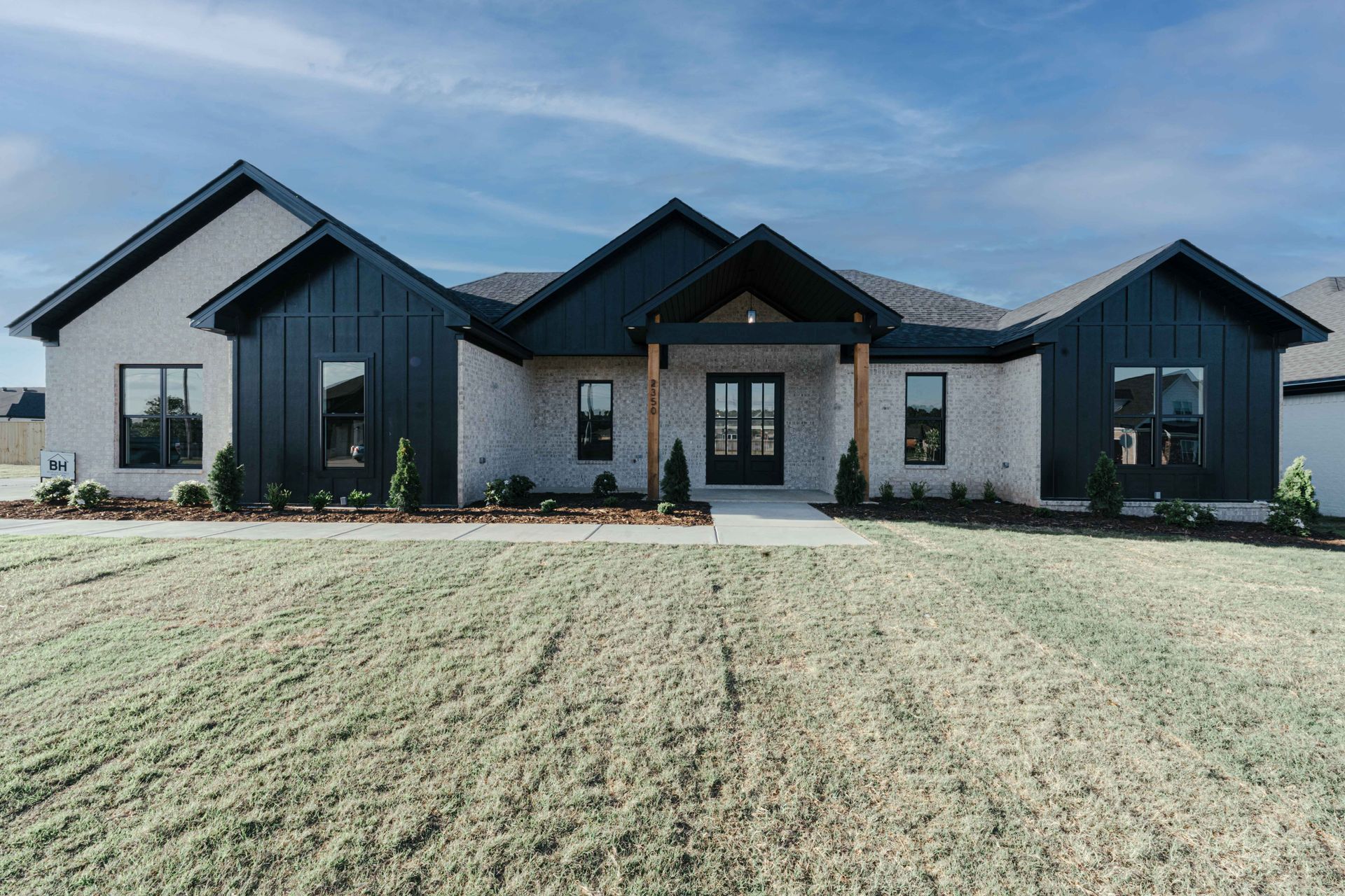 Exterior view of a modern black-and-white farmhouse-style home.