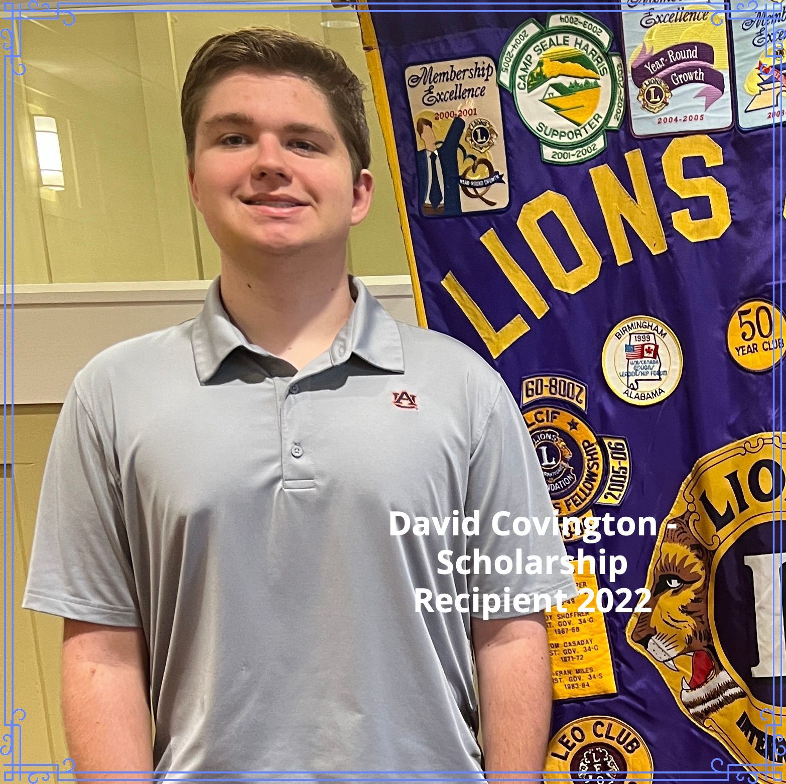 David Covington, a scholarship recipient, poses in front of a Lions Club banner.