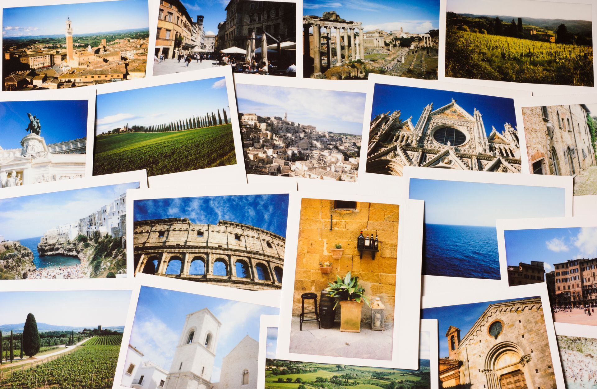 Display of instant film photos of Italy laid out on a table