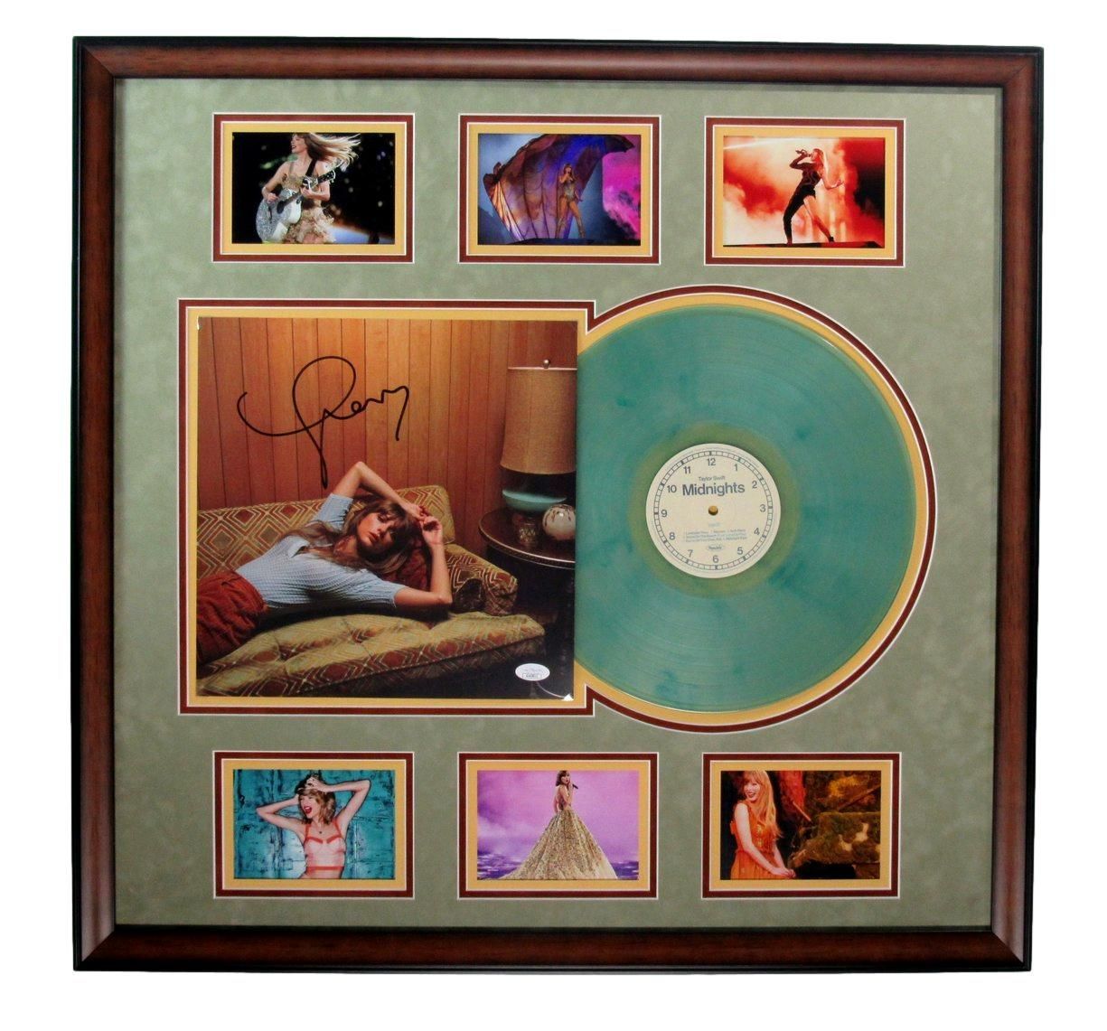 Framed display with a teal vinyl record and album cover autographed, surrounded by six small photos.
