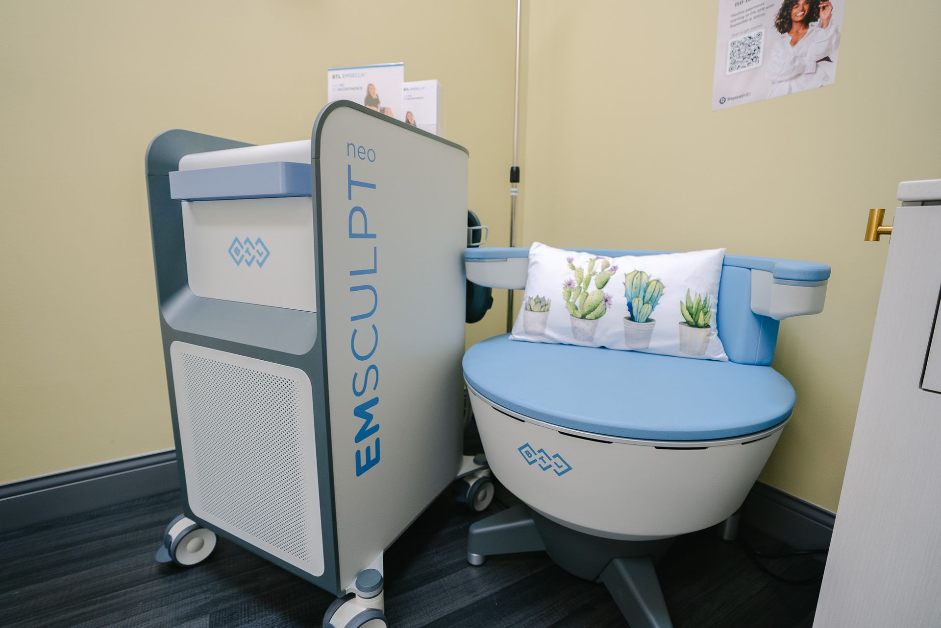Medical exam room with a blue-and-white examination chair and pediatric equipment