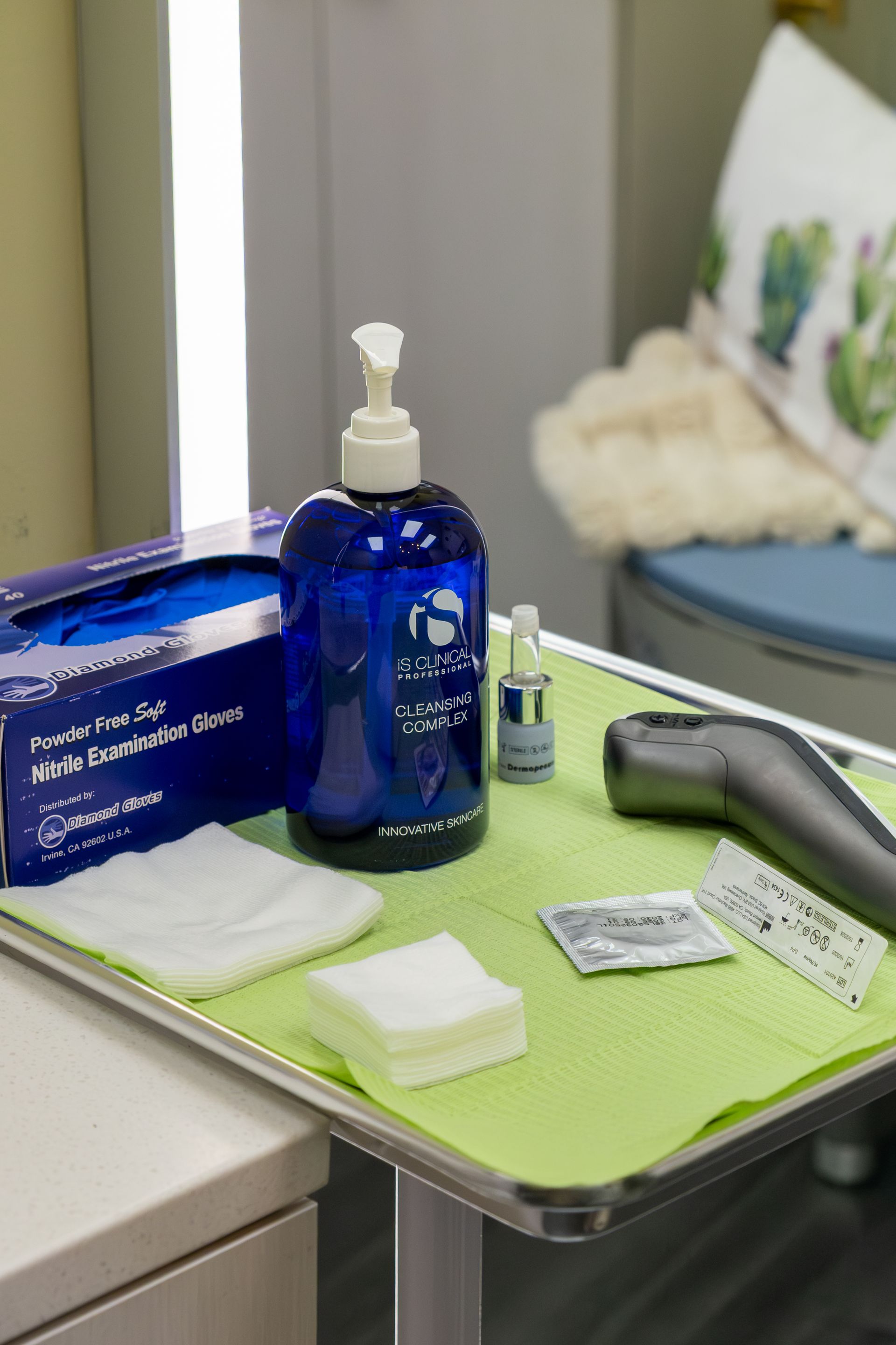 Bathroom tray with blue soap dispenser, lotion bottle, wipes, and grooming tools on a green mat