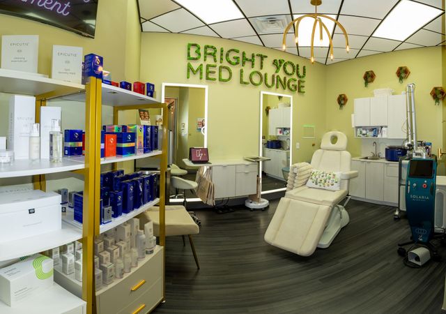 Bright You Med Lounge with cream recliners, shelves of products, and modern medical decor