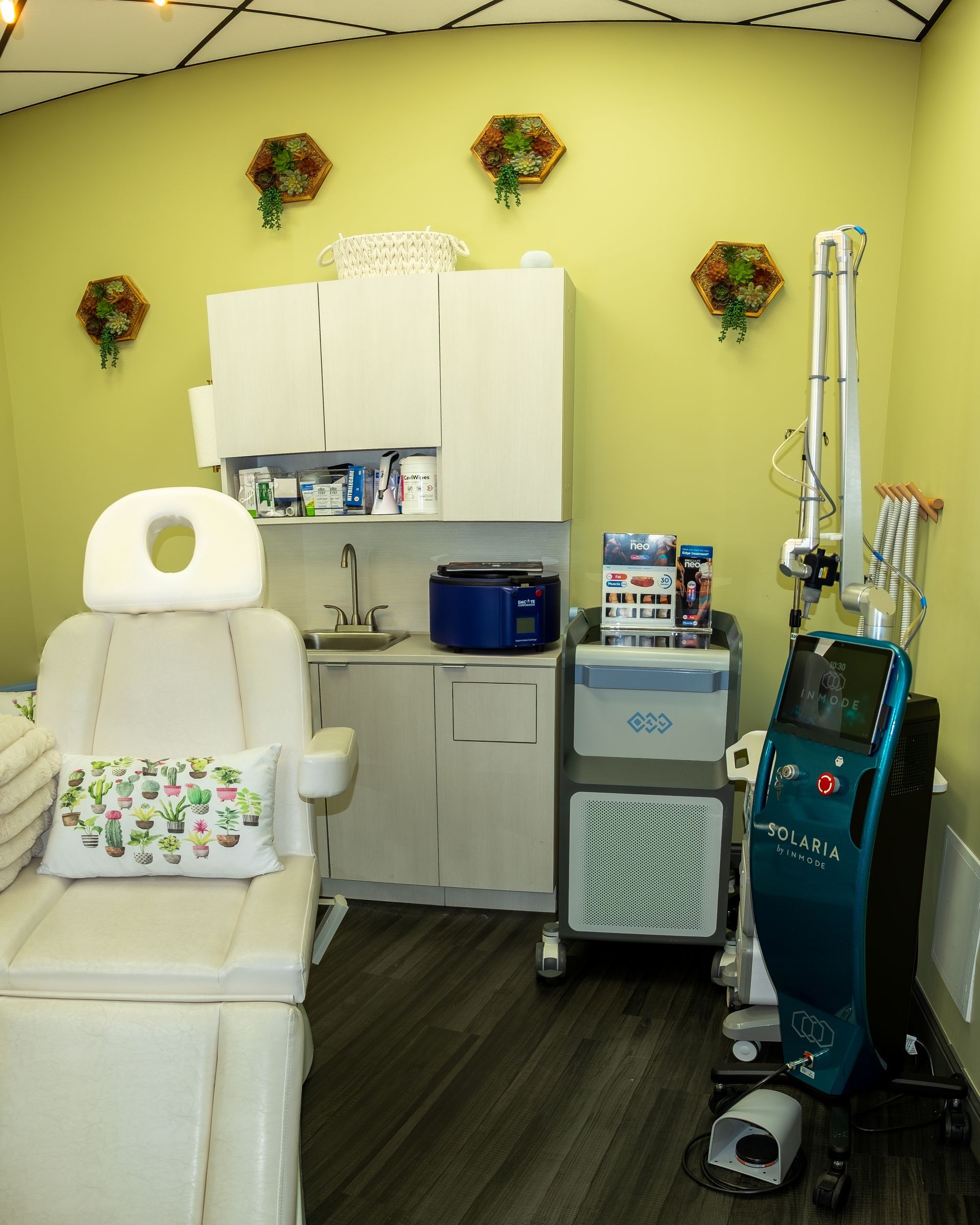 Pedicure spa room with a treatment chair, cabinets, sink, and nail salon equipment