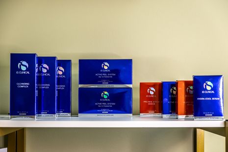 Blue and orange product boxes displayed on a shelf against a beige wall