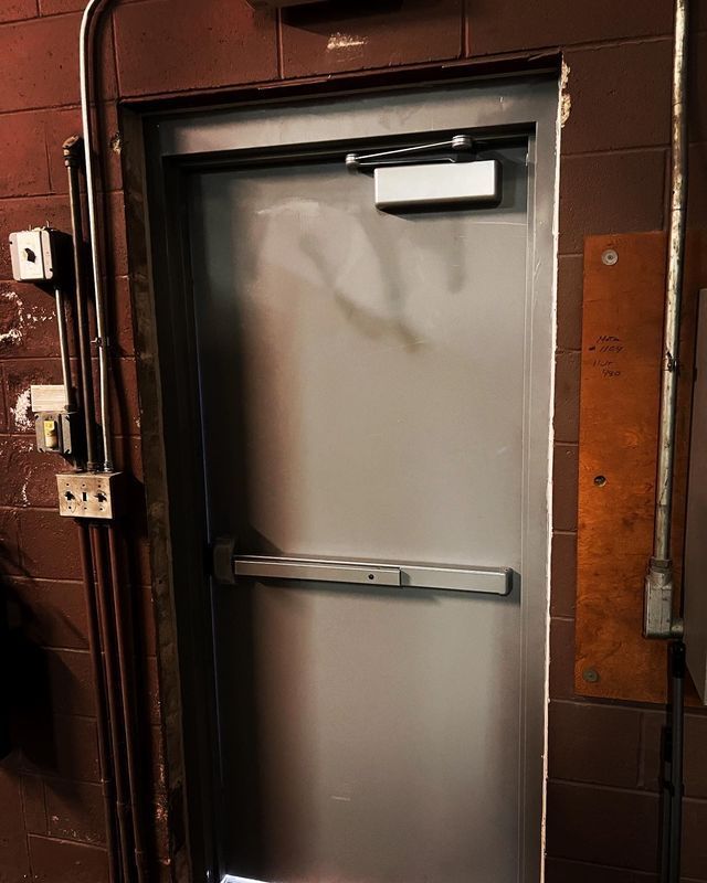 A door with a bar on it in a dark room