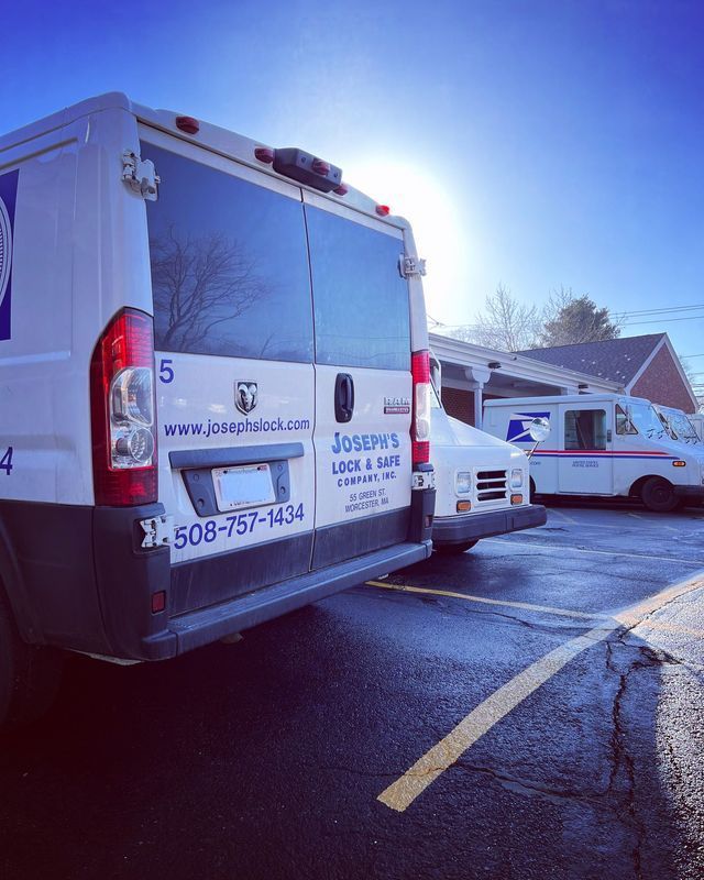 A row of vans are parked in a parking lot.