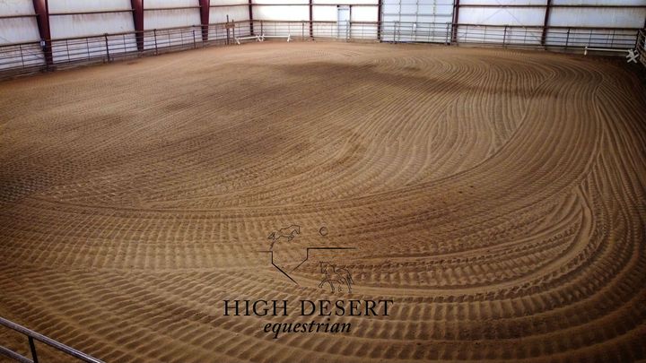 A large dirt arena with the words high desert equine farm on the bottom