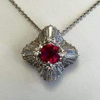 Ruby and diamond pendant necklace with a white gold chain.