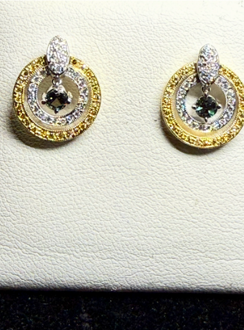 Two circular earrings with gold rims, white gold inner circles paved with diamonds, and a central dark stone.