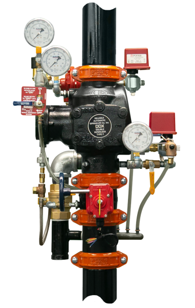A pipe with a lot of valves and gauges attached to it.